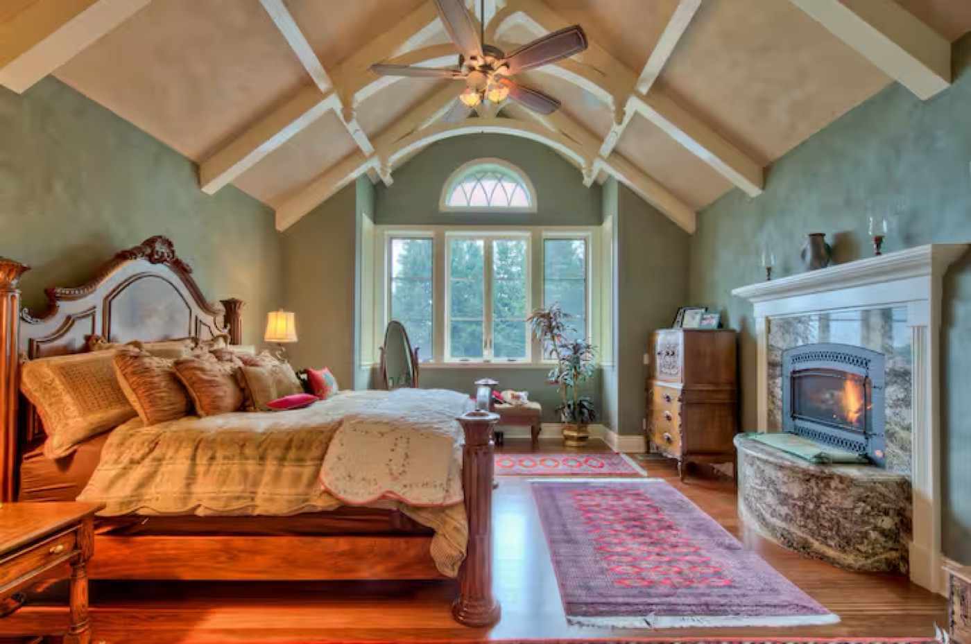 The king master suite with fireplace and vaulted ceilings